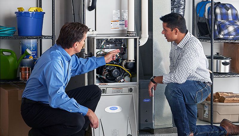 Technician evaluating a furnace for repair or replacement in San Bruno