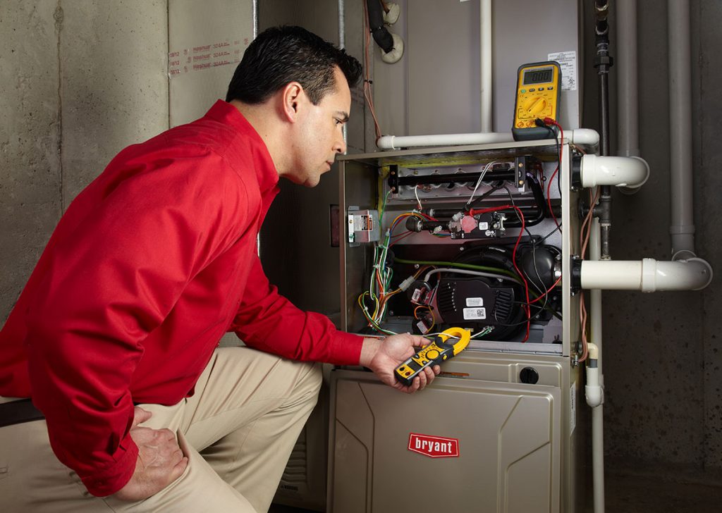 Heating technician diagnosing a furnace repair in San Bruno