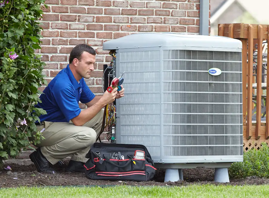 HVAC technician inspecting an outdoor AC unit in San Bruno