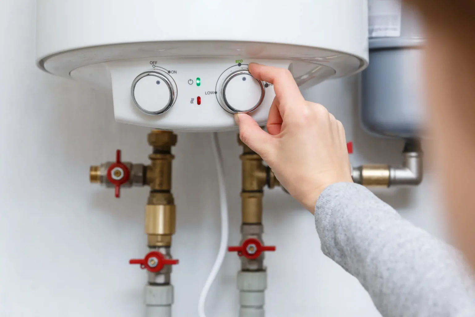 Technician adjusting a water heater in San Bruno